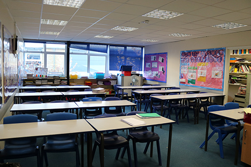Standard classroom setup with desks and chairs.