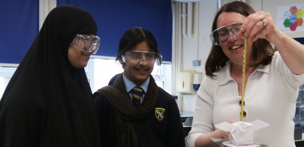 Two pupils with the Head of Science during an experiment