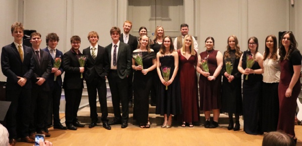 Year 13 students and Music teachers stood with flowers at the end of the Sixth Form Music Recital