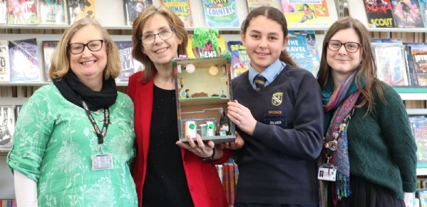 A group of people holding the winning prize for the Shared Reading Competition, announced at this year's BookFest