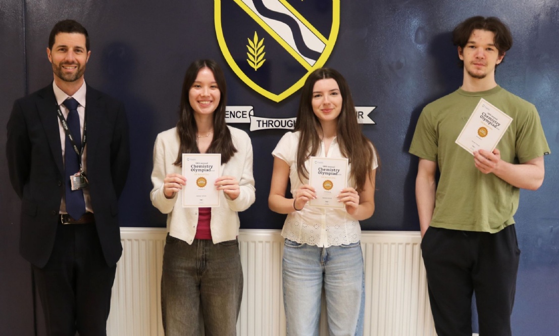 Students holding certificates and stood with Acting Headteacher